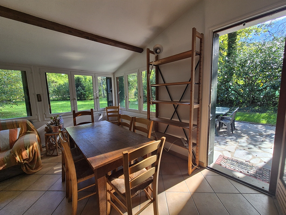 Indoor view of the living room from another angle with the door that leads to the terrace open.